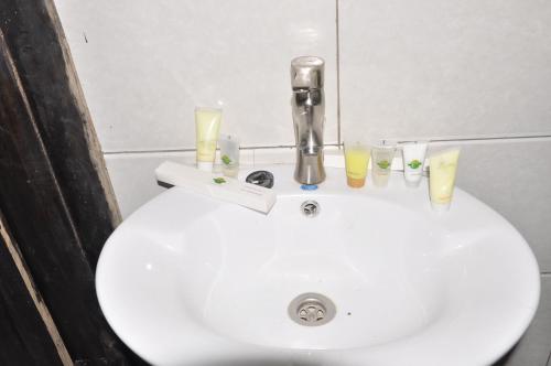 a white sink with candles on top of it at Nyungwe Nziza Ecolodge in Kitabi