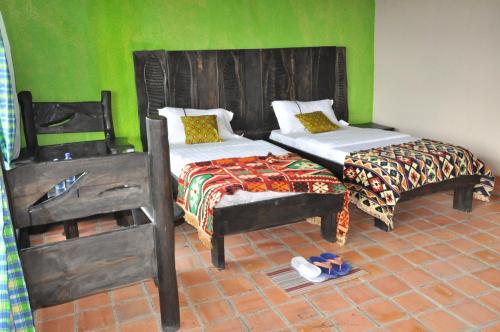 Postel nebo postele na pokoji v ubytování Nyungwe Nziza Ecolodge
