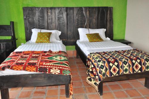 Postel nebo postele na pokoji v ubytování Nyungwe Nziza Ecolodge