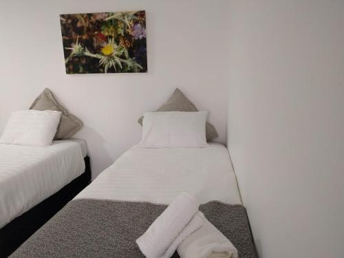 a room with two beds and a picture on the wall at Dead Sea Desert's Edge in Arad
