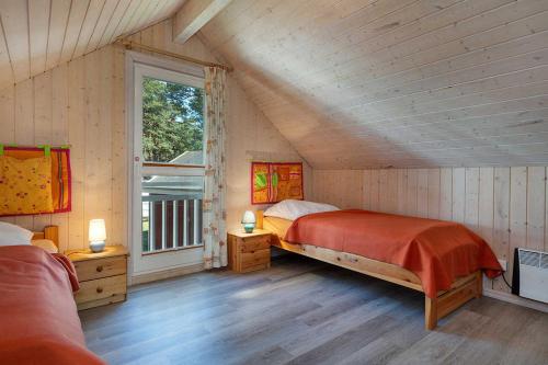 a bedroom with a large bed in a attic at Ferienhaus Sprottenkiste in Baabe