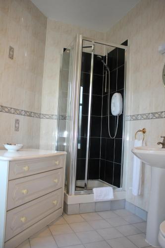 a bathroom with a shower and a sink at Ardmillan Hotel in Edinburgh