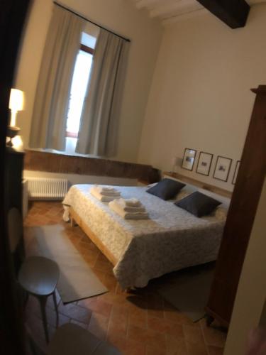 a bedroom with a large bed with a window at Sosta al Capitano in Pontassieve