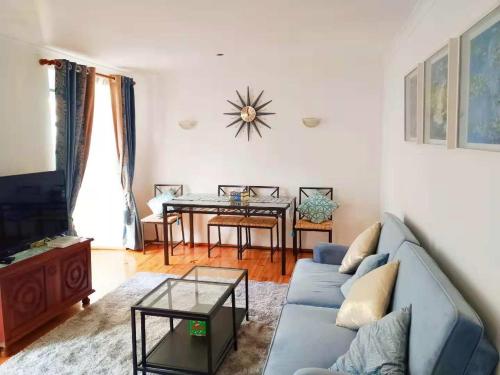 a living room with a blue couch and a table at Lisbon Baixa 208 Apartment-Chiado in Lisbon