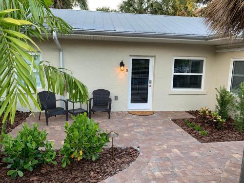 a house with two chairs and a patio at Twin Palms at Siesta in Siesta Key