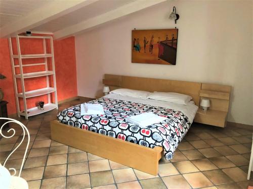 ナポリにあるCase Vacanze " Il Duomo" Napoliのベッドルーム1室(ベッド1台付)が備わります。壁には絵画が飾られています。