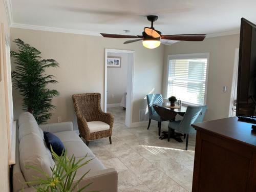 a living room with a couch and a ceiling fan at Twin Palms at Siesta in Siesta Key