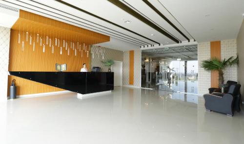 a lobby with a person sitting at a reception desk at MELISS EVENTS in Craiova