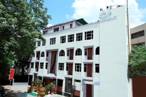 a white building with a sign on the side of it at Hotel Park Residency in New Delhi