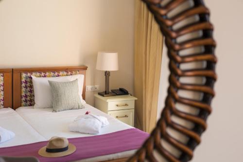 a bedroom with a bed with a hat on it at Sunrise Resort Hotel in Mithymna