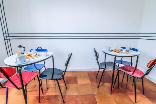 two tables and chairs with plates of food on them at Le stanze di Virgilio in Naples