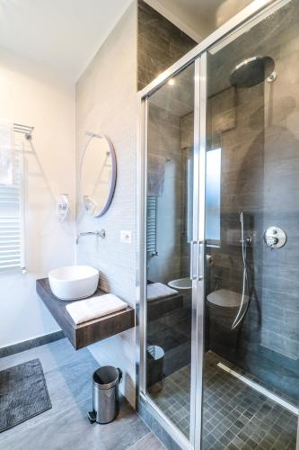 a bathroom with a shower and a toilet and a sink at Le stanze di Virgilio in Naples