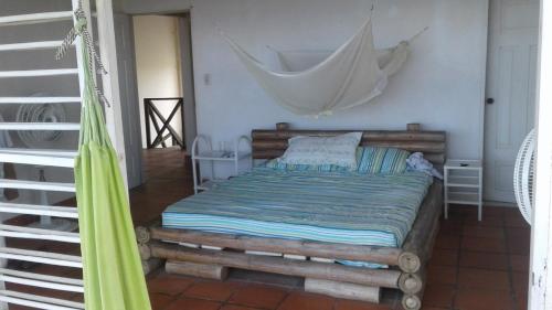 a bedroom with a bed with a hammock in it at Cabaña Playa De Los Venados in San Bernardo del Viento