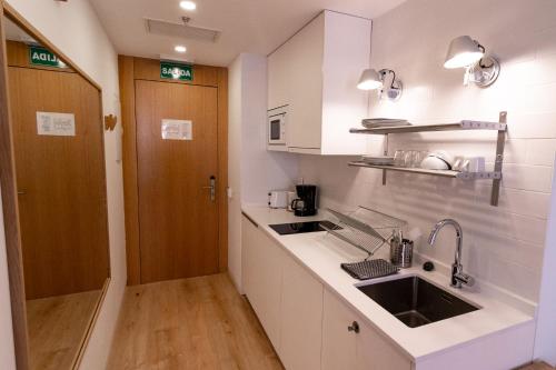 a kitchen with a sink and a counter top at Plaza Mayor Suites & Apartments in Madrid