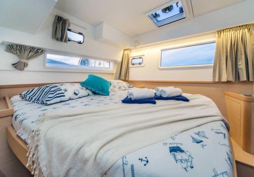 a bedroom with a large bed with two pillows on it at Luxury Catamaran Lagoon 42, AC & GN in Split