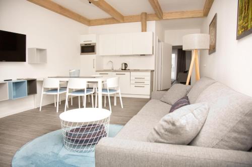 a living room with a couch and a table with chairs at Equitana Hotel Resort in Březnice