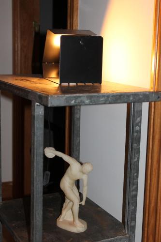 a table with a figurine on it with a laptop on it at Aritza Apartamentos Turísticos Rurales in Elizondo
