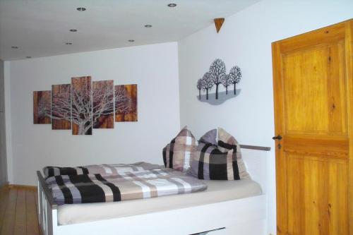 ein Schlafzimmer mit einem Bett mit drei Bäumen an der Wand in der Unterkunft Stiftsblick in Gernrode - Harz