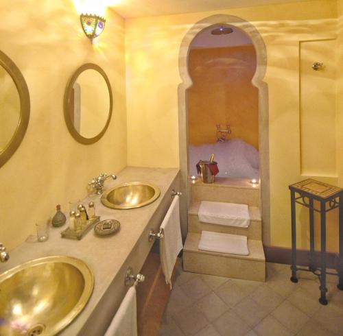 
a bathroom with two sinks and a mirror at Alcoba del Rey de Sevilla in Seville

