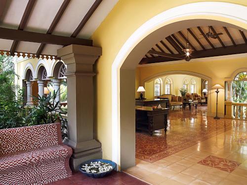 a lobby of a home with a couch and chairs at Taj Holiday Village Resort & Spa, Goa in Candolim