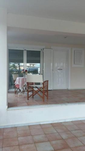 a living room with a table and a dining room at NN Luxury Room near Athens Airport in Spáta