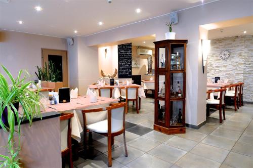 a dining room with tables and chairs in a restaurant at Il Piccolo Mondo in Luxembourg