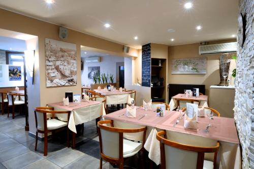 a restaurant with tables and chairs in a room at Il Piccolo Mondo in Luxembourg