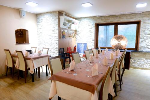 a dining room with long tables and chairs in a room at Il Piccolo Mondo in Luxembourg