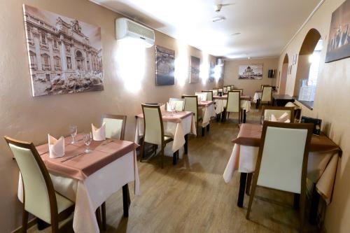 a dining room with tables and chairs in a restaurant at Il Piccolo Mondo in Luxembourg