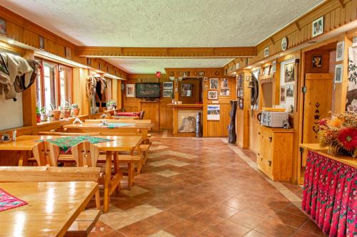 uma cozinha e sala de jantar com mesas e cadeiras de madeira em Dom wypoczynkowy Stoch Mądry em Zakopane