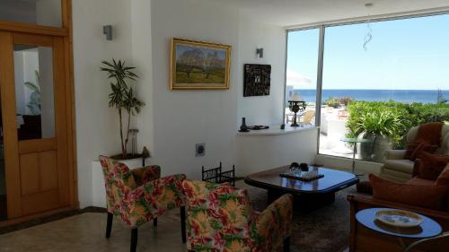 a living room with a view of the ocean at Posada de los Pajaros in Punta del Este