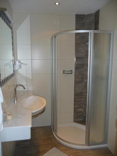 a bathroom with a shower and a sink at Familiengasthof St. Wolfgang in Spittal an der Drau