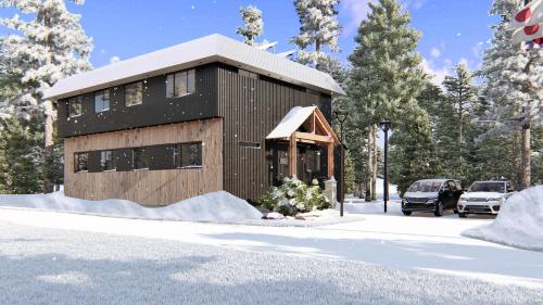 un petit bâtiment en bois dans la neige avec des voitures garées dans l'établissement Ski-in, Ski-out Hatsuyuki Apartments, à Hakuba