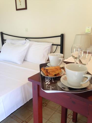 a tray of food on a table next to a bed at Villa Martha in Benitses
