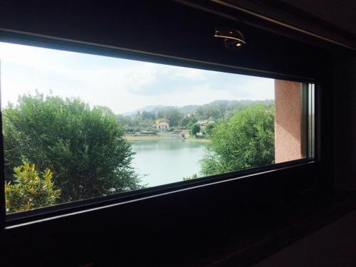 a view of a lake from a window at B&B Lanziani in Nemoli