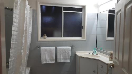 a bathroom with a sink and a mirror at 100 Cooloola Drive in Rainbow Beach