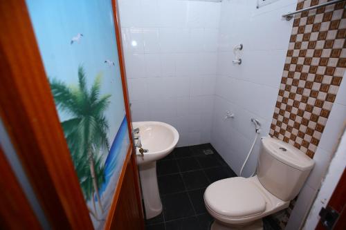 a bathroom with a toilet and a sink at Amadi Rest in Kataragama