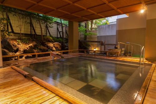 a swimming pool in a house with a pool at Shima Grand Hotel in Nakanojo
