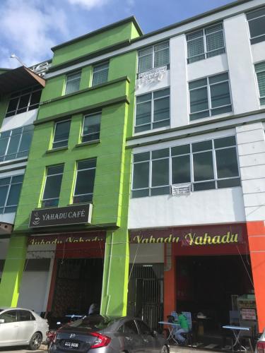 a colorful building with cars parked in front of it at SS Homestay Borneo Housing SL4A in Kuching