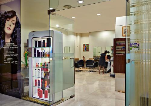 a room with a cosmetics store with a refrigerator at Pullman Kuala Lumpur City Centre Hotel & Residences in Kuala Lumpur
