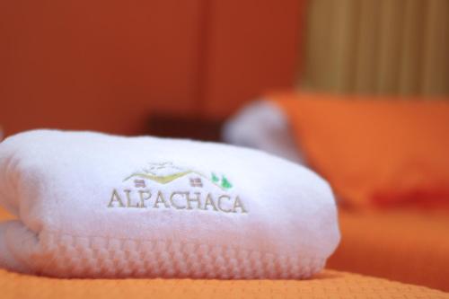 a white towel with anaggadia on it sitting on a table at Hostal Alpachaca - New Quito Airport in Tababela