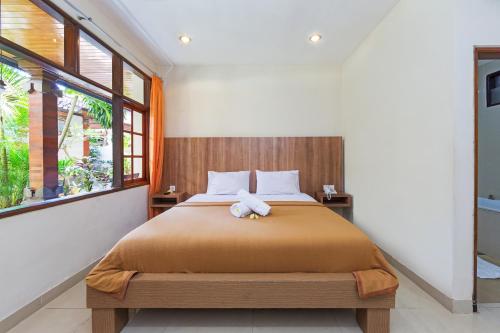 Postel nebo postele na pokoji v ubytování Simpang Inn Hotel