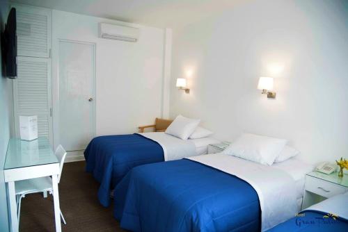Postel nebo postele na pokoji v ubytování Hotel Gran Palma Talara