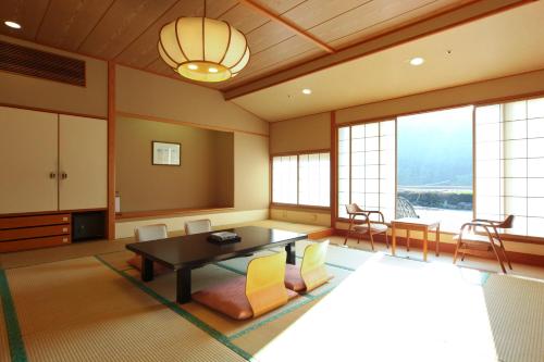 a living room with a table and chairs at Shima Grand Hotel in Nakanojo