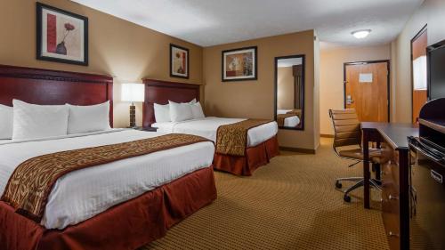 a hotel room with two beds and a desk at Hotel Lincoln Inn on Route 66 and near I-55 in Lincoln