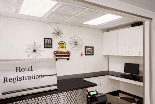 a room with a hotel registration sign on the wall at Baymont by Wyndham Glenwood in Glenwood