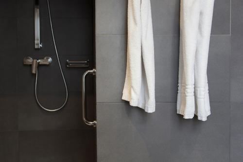 a bathroom with white towels hanging on a wall at Hostal Goya in Barcelona