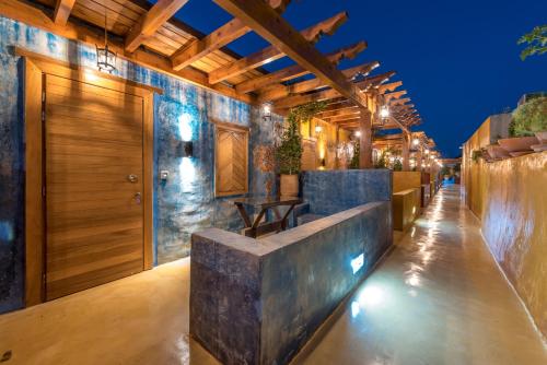un bar all'aperto con parete in pietra e soffitto in legno di 10GR Boutique Hotel & Wine Bar a Città di Rodi