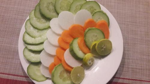 a plate of sliced vegetables on a table at Hotel Bhaktapur Inn in Bhaktapur