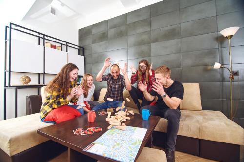a group of people sitting on a couch at Coffee Home Hostel in Lviv